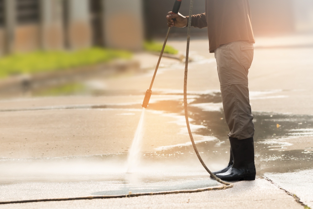 Worker cleaning driveway with gasoline high pressure washer ,professional cleaning services.
High pressure deep cleaning.